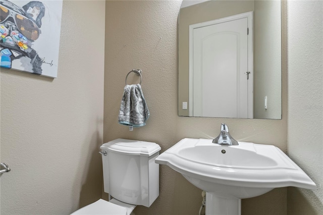 bathroom featuring sink and toilet