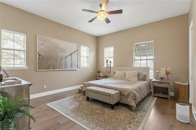 bedroom with hardwood / wood-style floors and ceiling fan