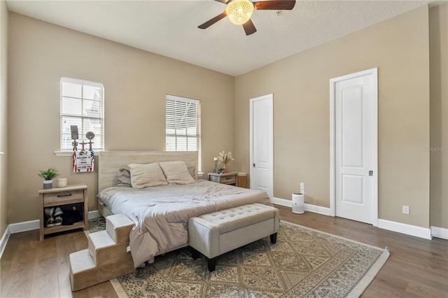 bedroom featuring ceiling fan and dark hardwood / wood-style flooring