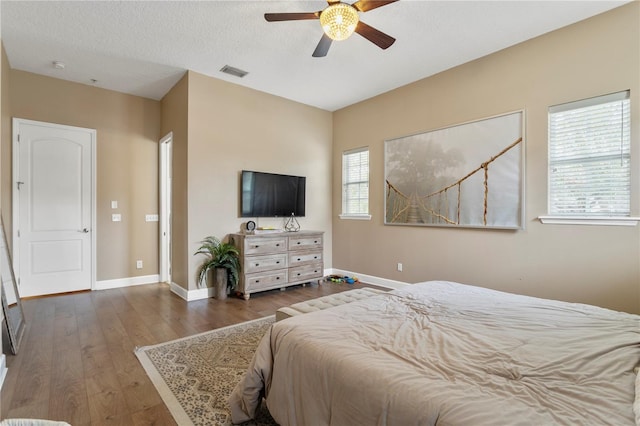 bedroom featuring ceiling fan and dark hardwood / wood-style floors