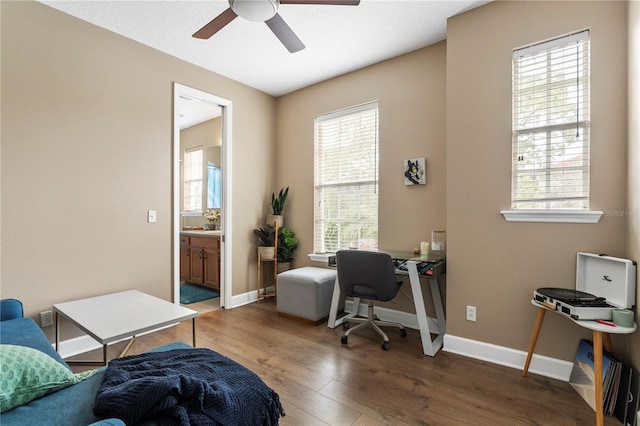 office space with ceiling fan and dark wood-type flooring