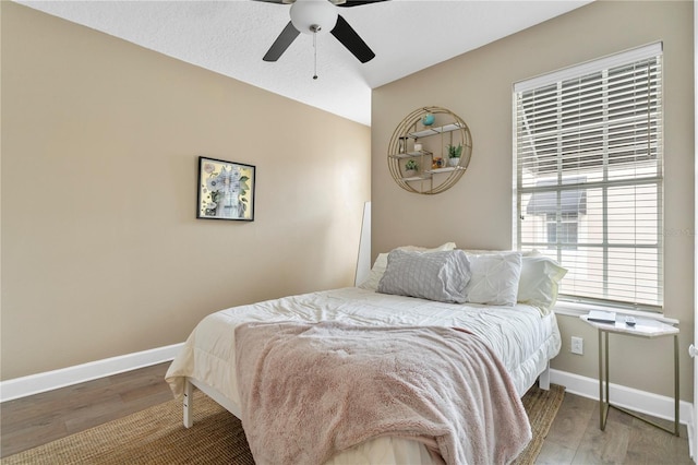 bedroom featuring ceiling fan and hardwood / wood-style floors