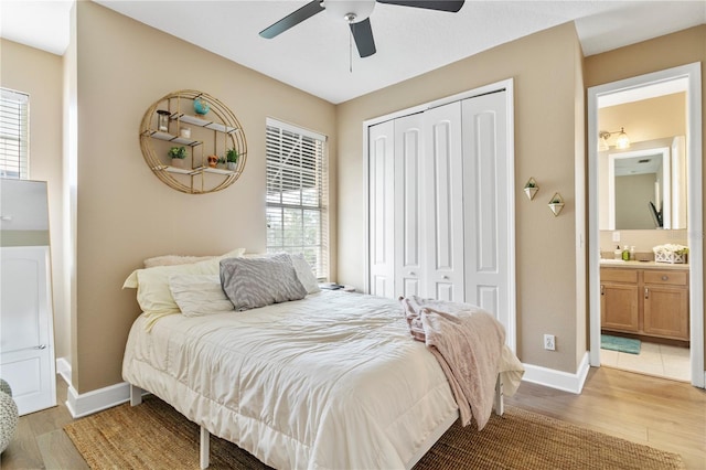 bedroom with multiple windows, light hardwood / wood-style flooring, a closet, and ceiling fan