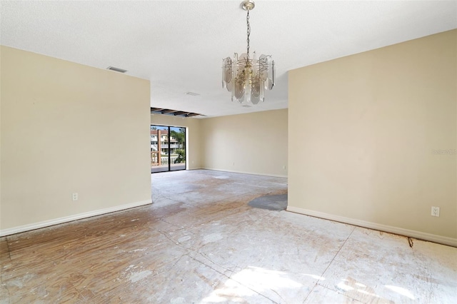 spare room with a chandelier