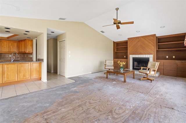 unfurnished living room featuring ceiling fan, light colored carpet, a fireplace, vaulted ceiling, and sink