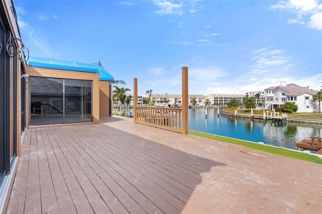 wooden terrace featuring a water view