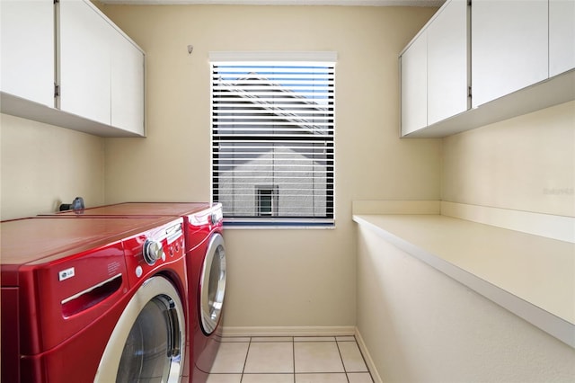 laundry room featuring light tile patterned floors, cabinets, and washer and dryer