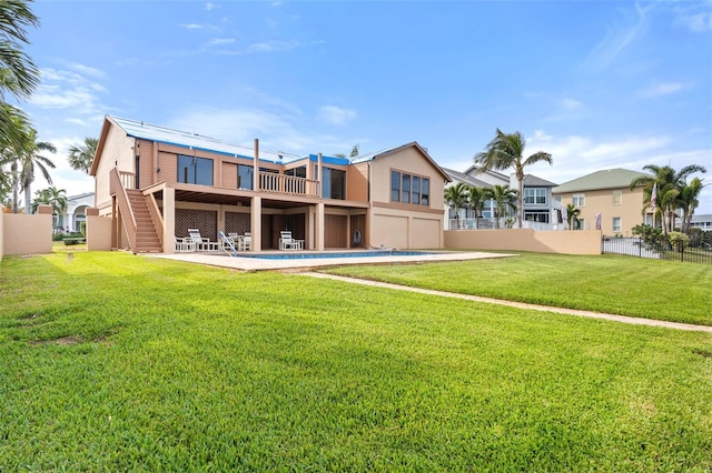 rear view of property with a yard and a patio