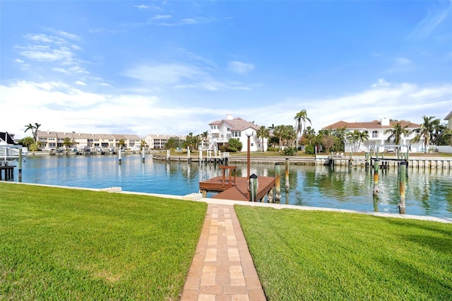 view of dock featuring a water view and a yard