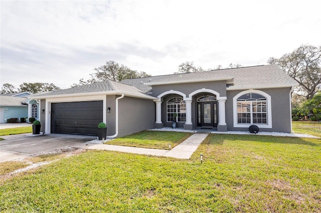 ranch-style home with a garage and a front yard