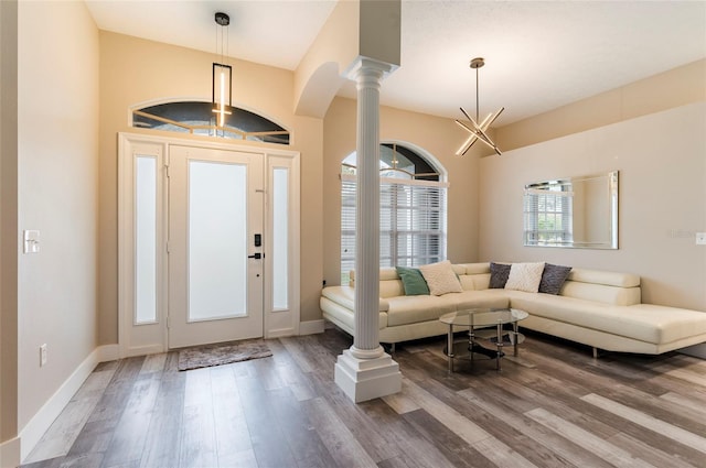 entrance foyer featuring hardwood / wood-style flooring and ornate columns