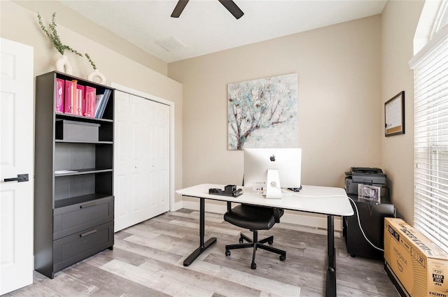 home office featuring hardwood / wood-style flooring and ceiling fan