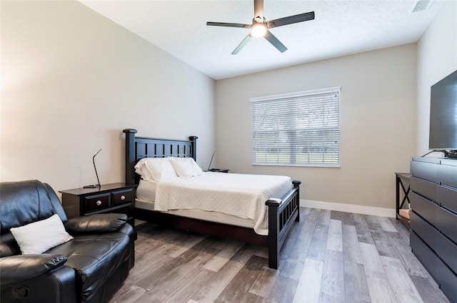 bedroom with ceiling fan and light wood-type flooring