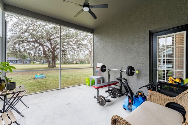 sunroom featuring ceiling fan