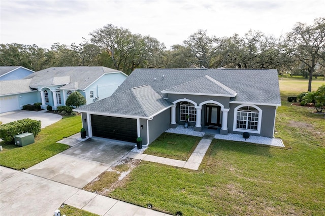 ranch-style home featuring a garage and a front yard