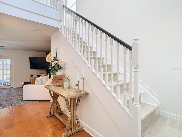 stairs featuring hardwood / wood-style flooring