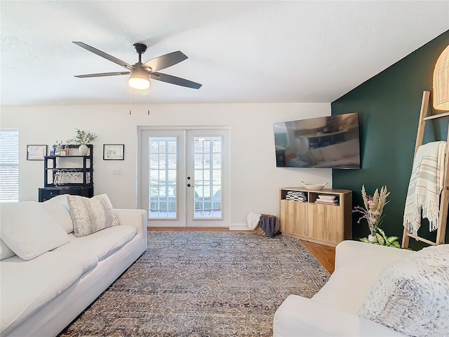 living room featuring hardwood / wood-style floors, french doors, and ceiling fan