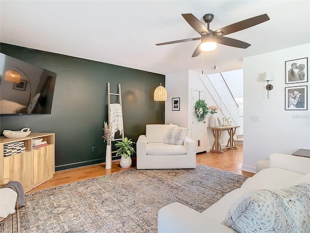 living room with hardwood / wood-style flooring and ceiling fan