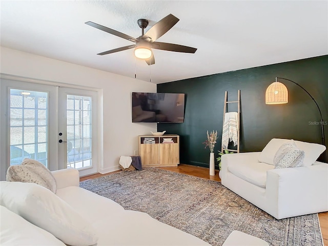 living room featuring french doors, ceiling fan, and wood-type flooring