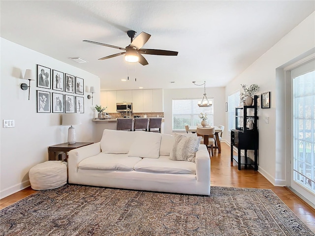 living room featuring hardwood / wood-style floors, a wealth of natural light, and ceiling fan