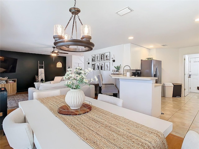 dining space featuring light tile patterned floors and ceiling fan