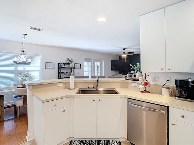 kitchen with sink, white cabinets, and dishwasher