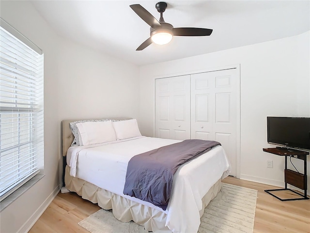 bedroom featuring a closet, ceiling fan, and light wood-type flooring