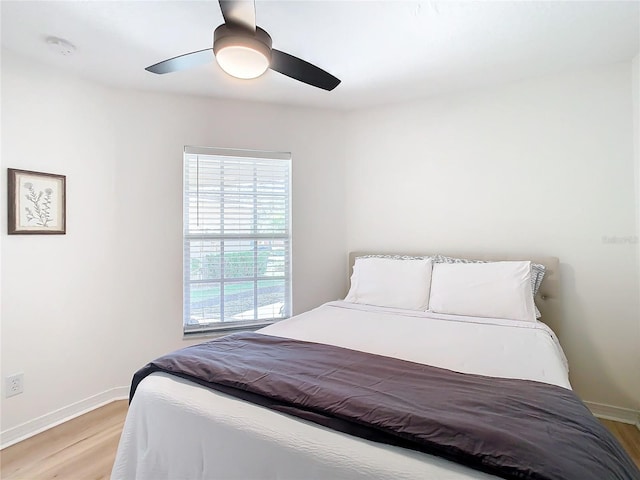 bedroom with ceiling fan and light wood-type flooring