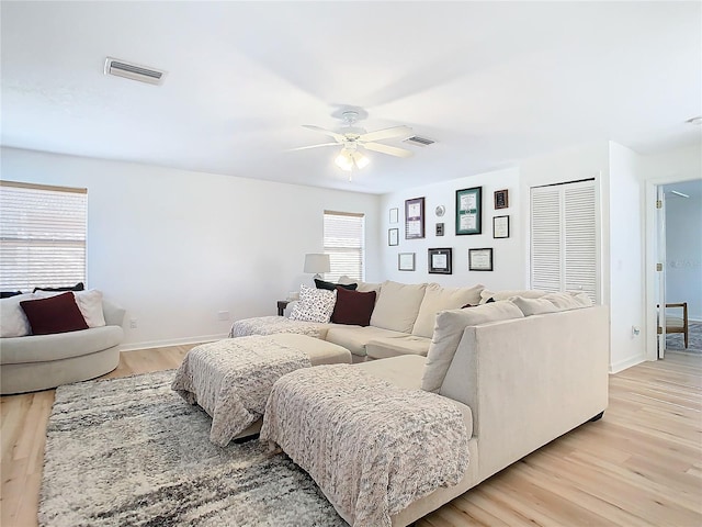 living room featuring ceiling fan and light wood-type flooring