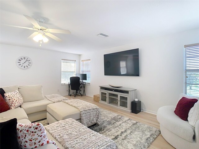 living room with ceiling fan and light wood-type flooring