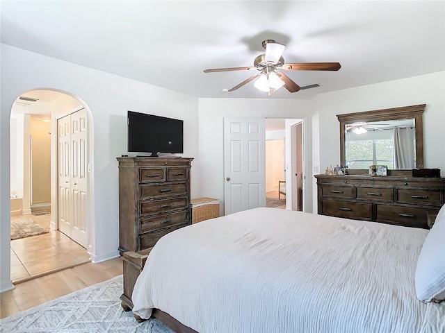 bedroom with a closet, ceiling fan, and light hardwood / wood-style flooring