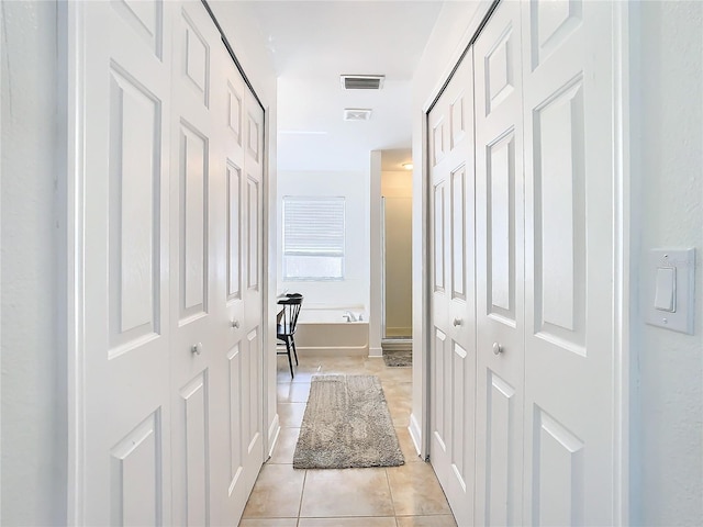 hallway with light tile patterned floors