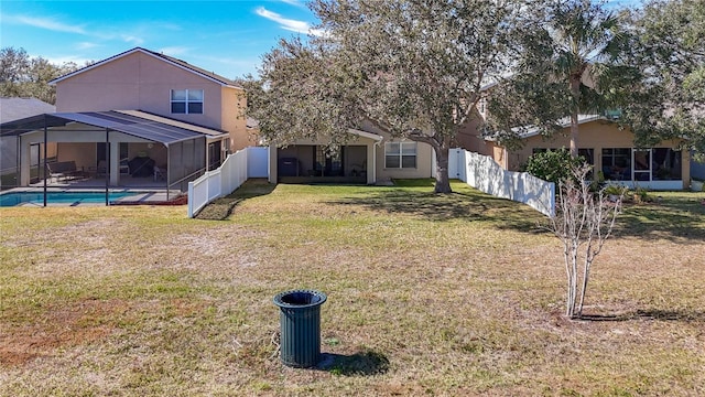 view of yard featuring a fenced in pool and a lanai