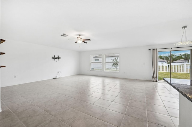 spare room featuring ceiling fan and light tile patterned floors