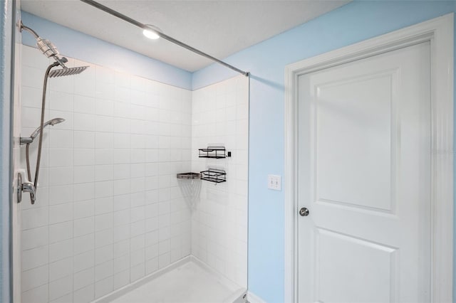 bathroom with tiled shower