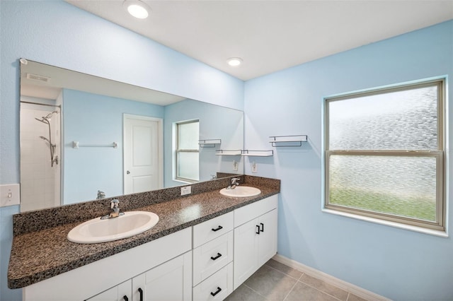 bathroom with a shower, tile patterned floors, and vanity