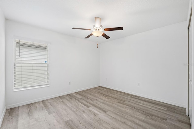 empty room featuring light wood-type flooring and ceiling fan