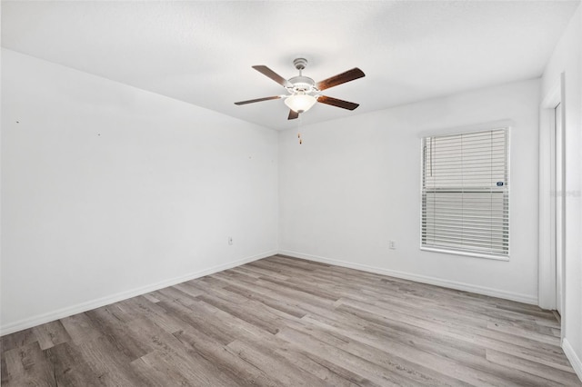 empty room with ceiling fan and light wood-type flooring