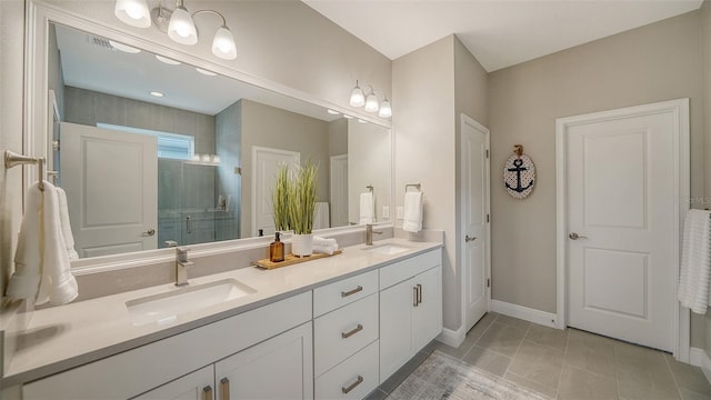 bathroom featuring vanity, tile patterned floors, and a shower with door