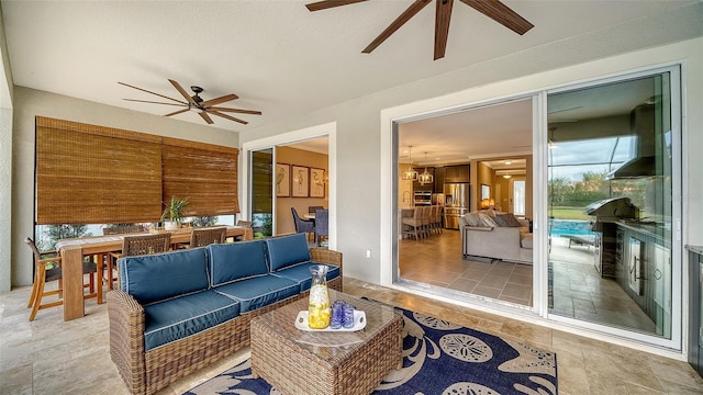 interior space with an outdoor hangout area and ceiling fan