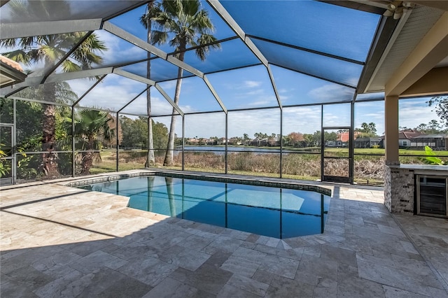 view of swimming pool featuring a lanai and a patio area