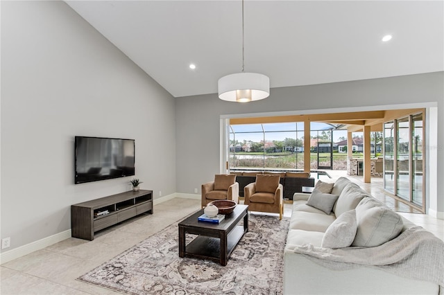 living room featuring high vaulted ceiling, light tile patterned flooring, and a healthy amount of sunlight