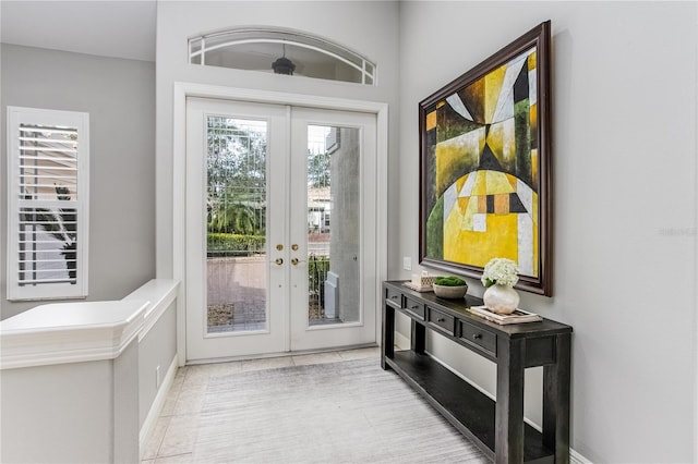 doorway with light tile patterned floors and french doors