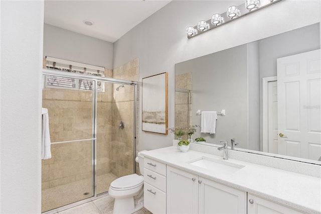 bathroom featuring toilet, tile patterned flooring, a shower with shower door, and vanity