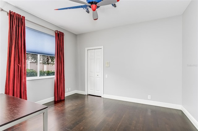 spare room with ceiling fan and dark hardwood / wood-style flooring