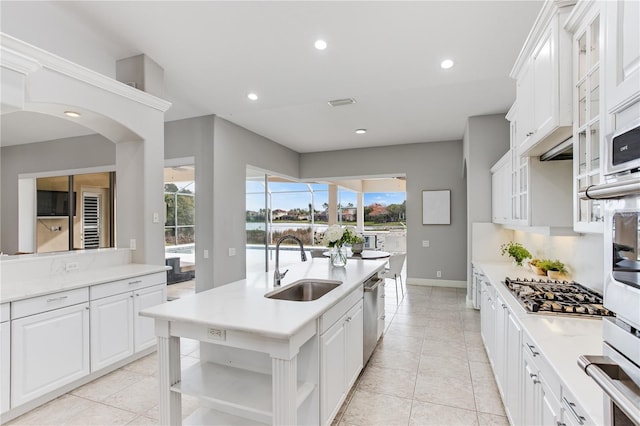 kitchen featuring sink, white cabinetry, light tile patterned floors, and stainless steel appliances