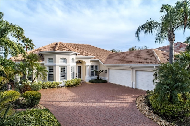 mediterranean / spanish house featuring a garage