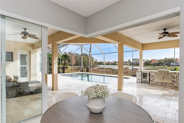 view of swimming pool with area for grilling, a lanai, a patio, and ceiling fan