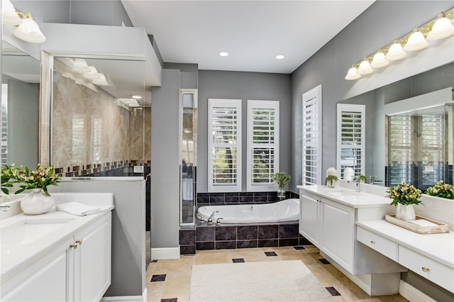 bathroom with shower with separate bathtub, tile patterned floors, and vanity