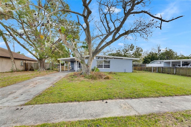 view of front of house with a front yard and a carport